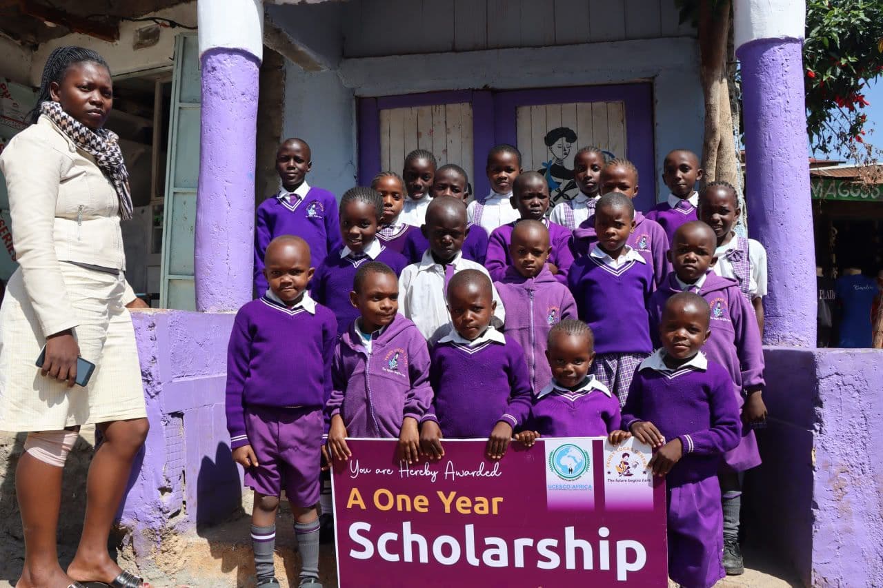 Students with teacher and sponsorship cheque