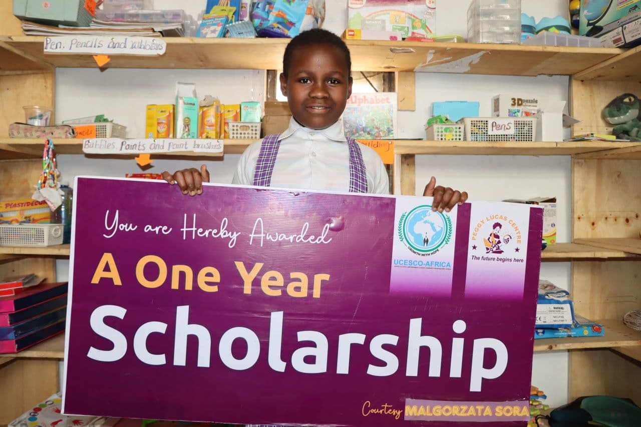 Happy girl with sponsorship cheque